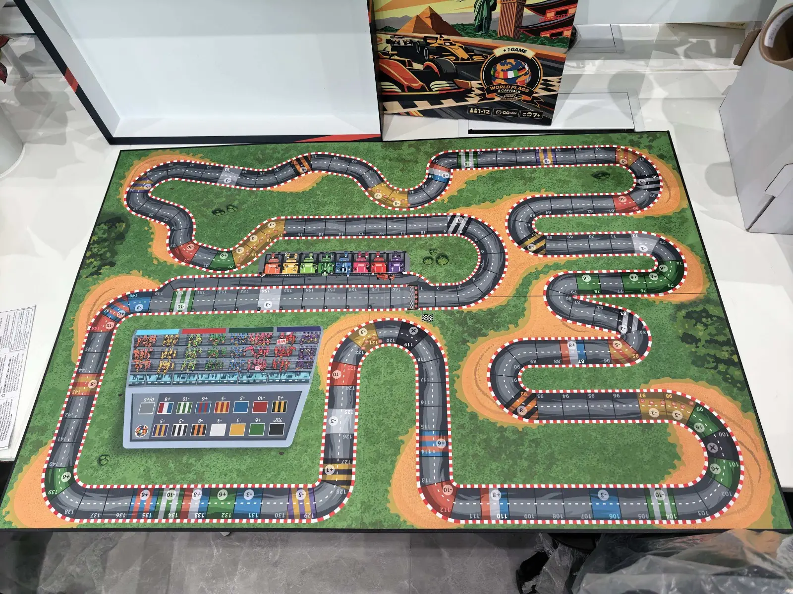Colodeni physical race board laid out on a table with box behind it